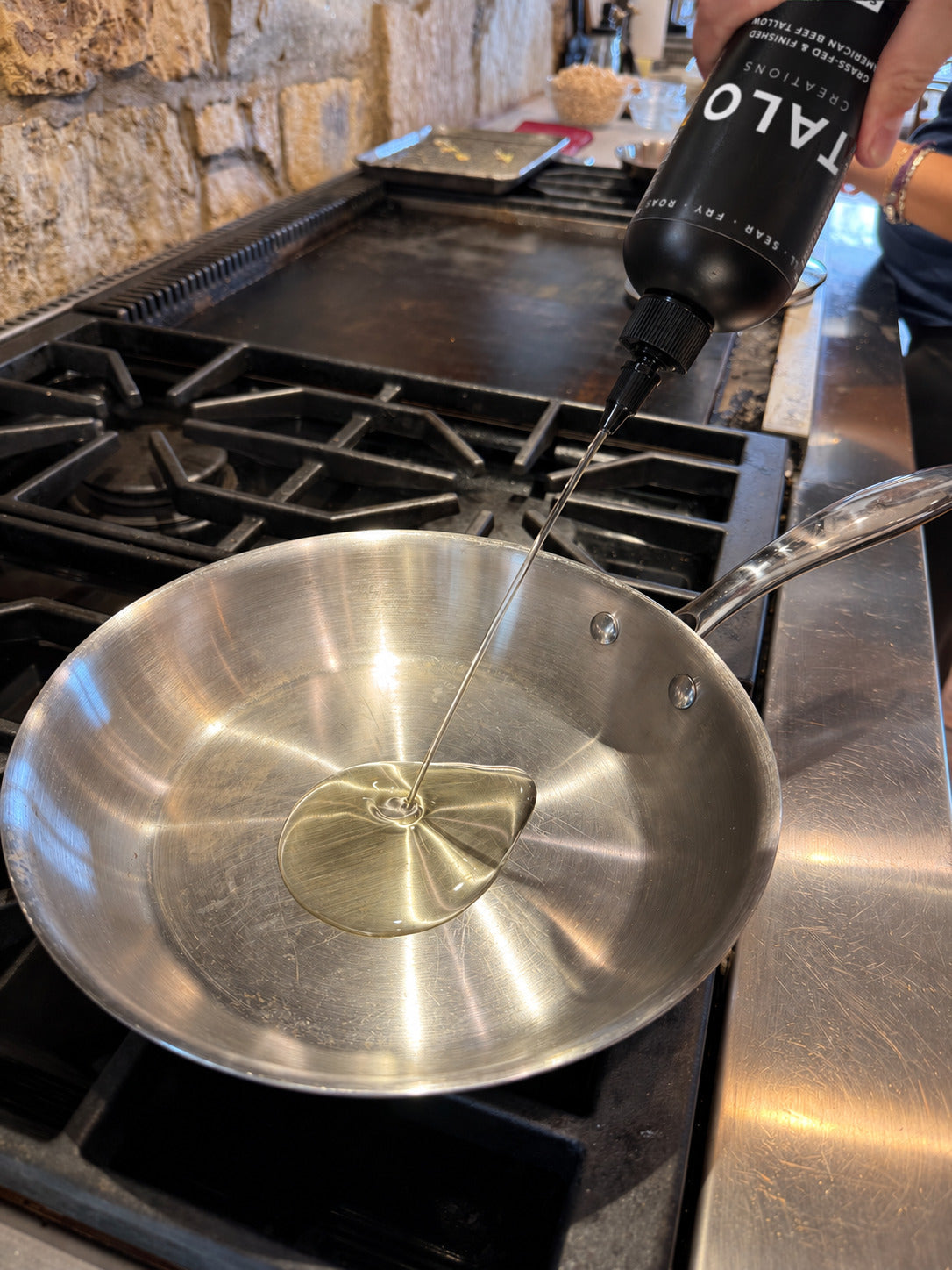 TALO SQUEEZE poured into a stainless pan on the stove