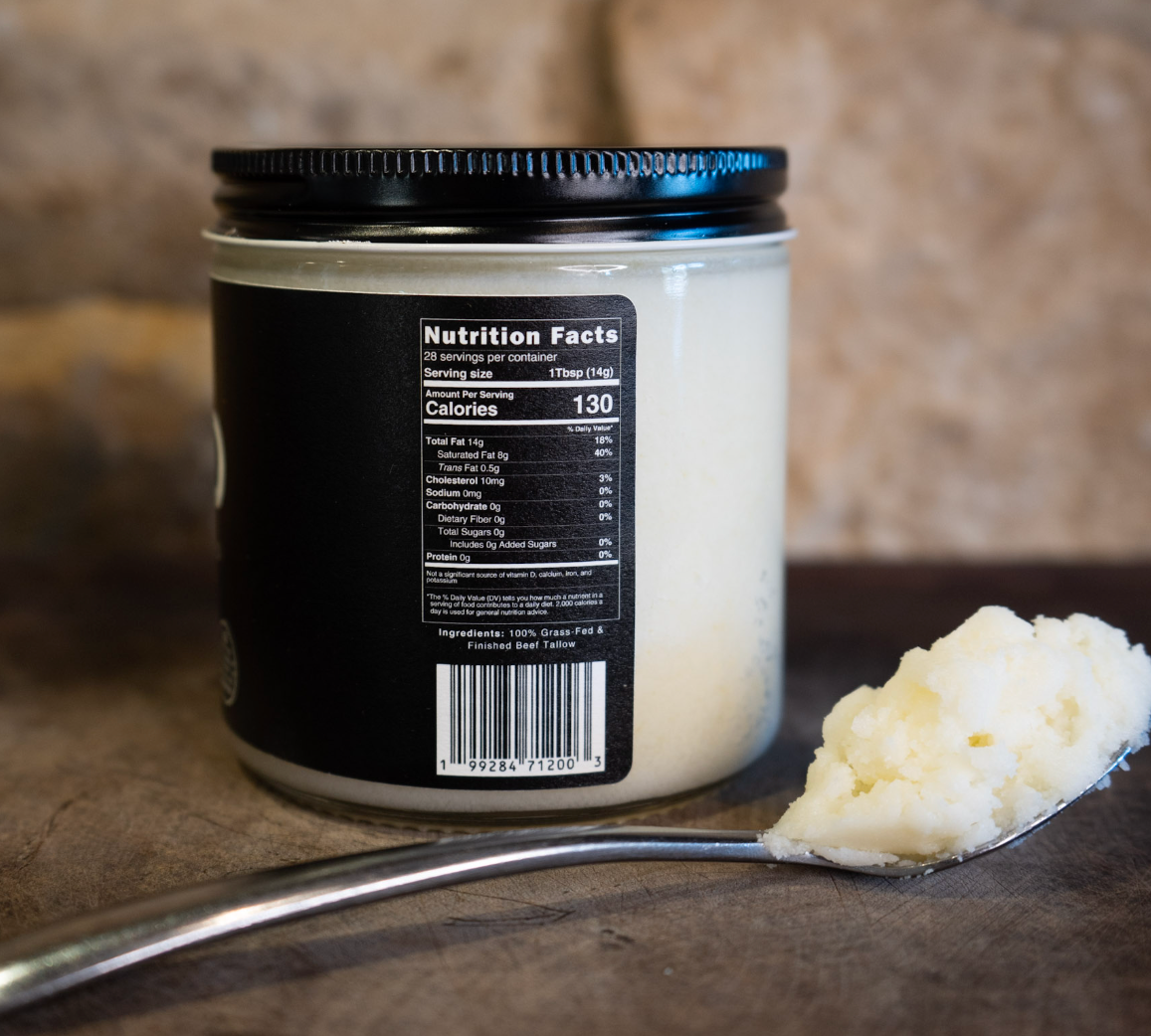 Back of TALO beef tallow jar showing the nutrition facts label, next to a spoonful of white tallow