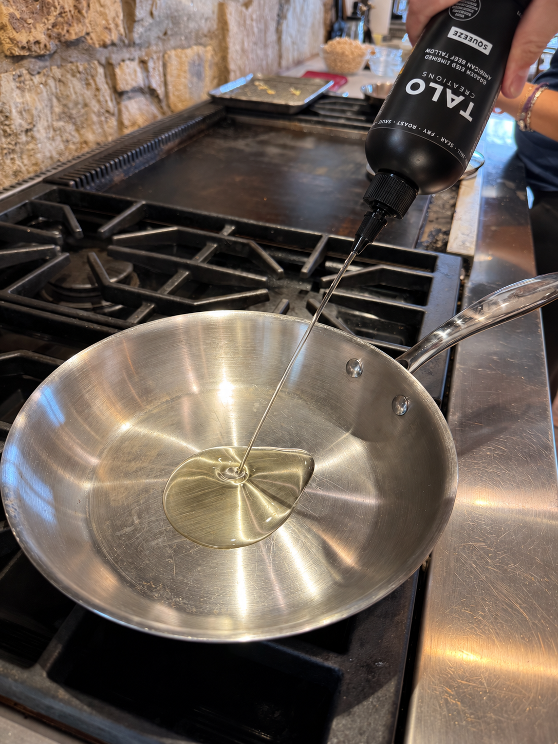 TALO Squeeze poured into a stainless pan on the stove